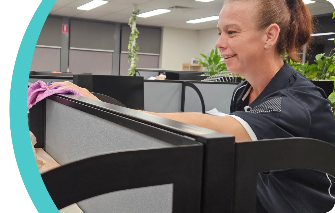 Flawless Clean team member detailing an office workstation